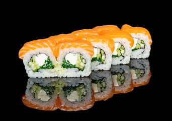 sushi and rolls with different fillings on a black background with reflection