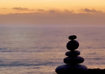 Stone Cairn At The Beach At Sunset