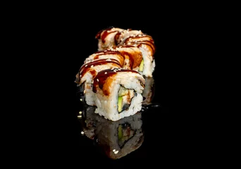 Selbstklebende Fototapeten sushi and rolls with different fillings on a black background with reflection © Olexandr Tytarchuk