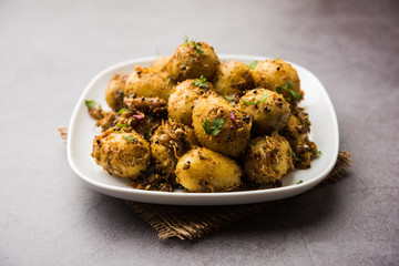 Jeera Aloo - Potatoes Flavoured With Cumin seeds and spices. popular Indian main course recipe. served in a bowl. selective focus