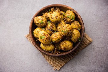 Jeera Aloo - Potatoes Flavoured With Cumin seeds and spices. popular Indian main course recipe. served in a bowl. selective focus