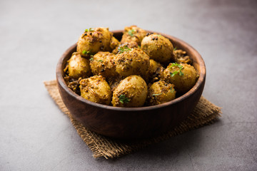 Jeera Aloo - Potatoes Flavoured With Cumin seeds and spices. popular Indian main course recipe. served in a bowl. selective focus