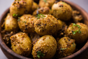 Jeera Aloo - Potatoes Flavoured With Cumin seeds and spices. popular Indian main course recipe. served in a bowl. selective focus