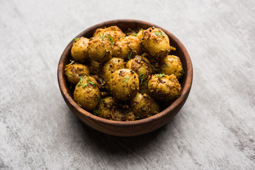 Jeera Aloo - Potatoes Flavoured With Cumin seeds and spices. popular Indian main course recipe. served in a bowl. selective focus