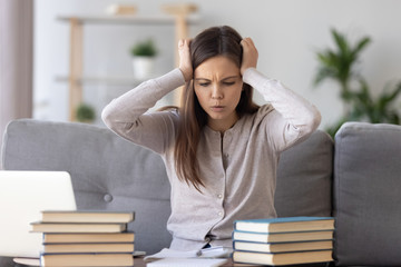 Upset girl student worried making mistake studying