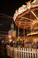 Christmas carousel and Kremlin on Red square in Moscow, Russia. New year celebration and fairy....