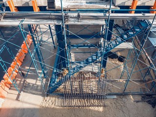 The temporary staircase was built for the construction with prevent falling. scaffolding in the construction zone