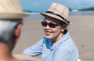 Fototapeta premium Asian couple senior elder retirement resting at beach honeymoon family together happiness people lifestyle