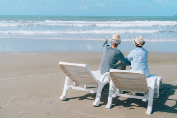 Asian couple senior elder retirement resting at beach honeymoon family together happiness people lifestyle