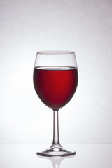 Glass of red wine on a light background
