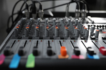 Modern audio mixing console, closeup. Music equipment