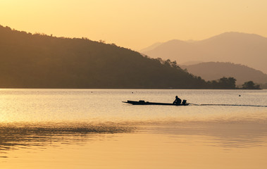 Fototapeta premium sunset or sunrise over river and mountain in Kanchanaburi Province, Thailand.