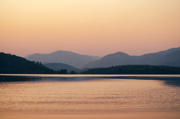 sunset sunrise over river and mountain