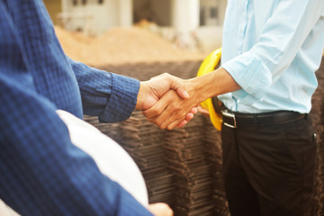 Engineering hands shake at work place building construction estate project success,Business people shake hand agreement investment business