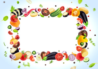 Obraz premium Vegetable isolated on white background, frame made of different flying vegetables, herbs and spices, with copy space
