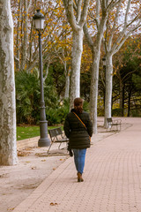 Woman walking through a park in Madrid. Spain