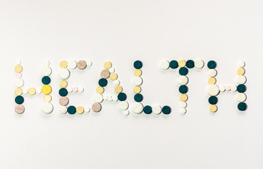 word health made from pills on a white background, healthcare concept.