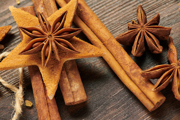 Handmade decoration from dried fruits on a dark wood background. Top view.