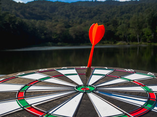 Dart Board Isolated on water view background, Setting challenging business goals And ready to...
