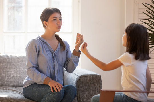 Female Speech Therapist Doing Exercise, Speaking With Little Girl Patient