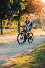 Fototapeta premium School girl riding bicycle