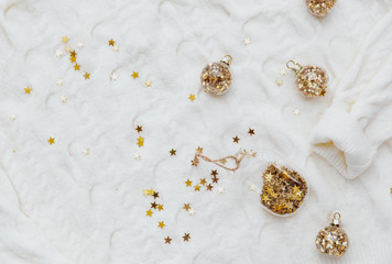 Golden stars glitter over white warm sweater. Minimal Festive holiday background