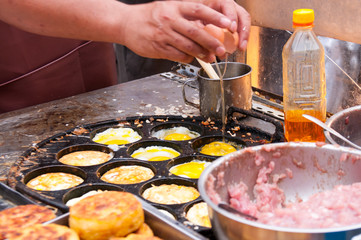 The chef prepares a meal in the food market in China, street food in summer