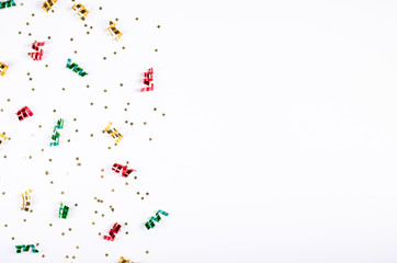 Colored confetti composition on gray background, party and celebration decoration.