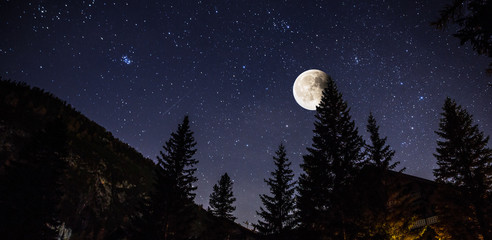 Starry sky and full moon over the Alps, Italy