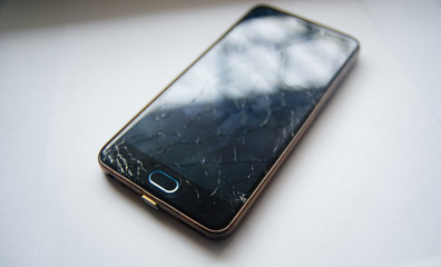 Broken glass of smart phone.  Selective focus. White background.