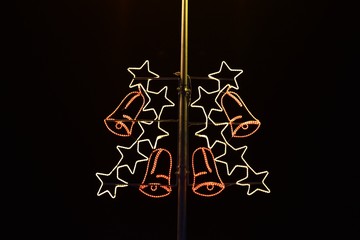 Fototapeta premium Image shows electric pillar embellished with Christmas stars and bells.