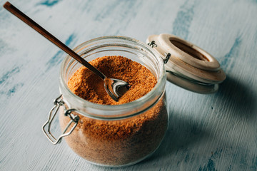 Panela sugar background. Close up view of raw cane sugar in a jar. 