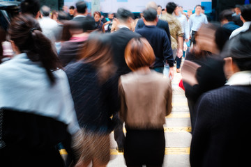 motion blur of business people crossing street 