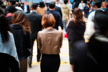 motion blur of woman from behind crossing street