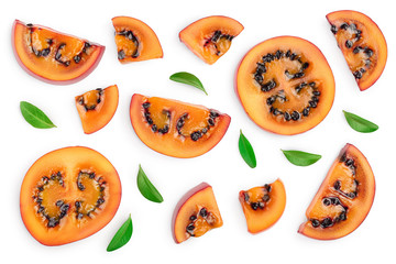 Fresh tamarillo fruit slices with leaves isolated on white background. Top view. Flat lay. Set or collection