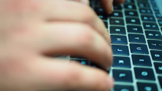 Side view of man typing fast on laptop keyboard. Chatting with friends on computer.