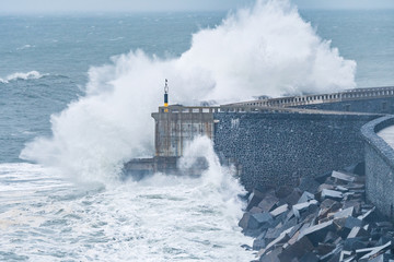 powerful waves breaking at breakwater during a storm