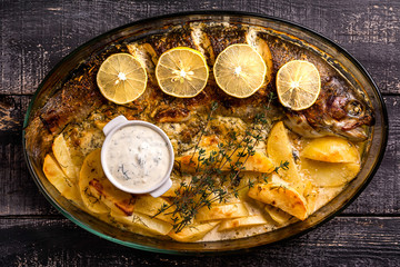 Exposition of fish and chips in dishes, very tasty food on wooden table.
