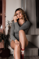 Fototapeta premium Young beautiful blonde model posing in her room. Nice body, shiny pure skin, natural makeup, attractive look