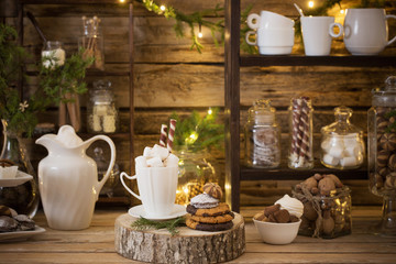 Fototapeta na wymiar Christmas decoration cocoa bar with cookies and sweets on old wo