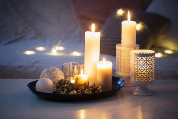 Christmas decoration   with burning candles on  white table agai