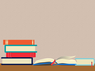 Front view of a stack of books next to an open book on the desk against a patterned wall. Use for themes on studying, education, reading and research. Include copyspace