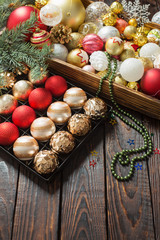 Christmas balls in box on dark wooden background