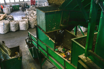 Conveyor belt at a garbage recycling plant. Equipment for waste sorting. The concept of waste management, management, reuse, recycling and recovery