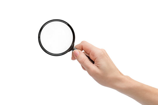 Woman's hand holding magnifying glass. Isolated on white.