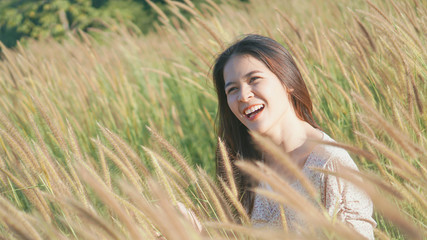 Young happy woman tourist sit alone for relaxing and sightseeing good view around green the Meadow.vintage tone.selective focus.
