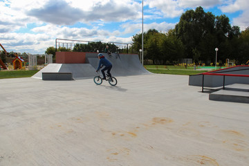 man in a helmet rides a bmx bike in a skate park