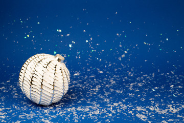Christmas white ball on a blue background.