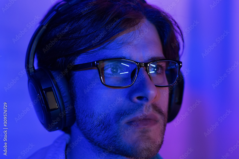 Poster Hacking concept. Man in glasses looking at computer screen