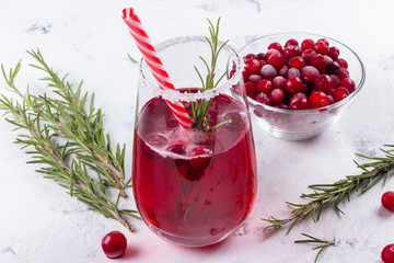 Cranberry cocktail with xmas straw and rosemary